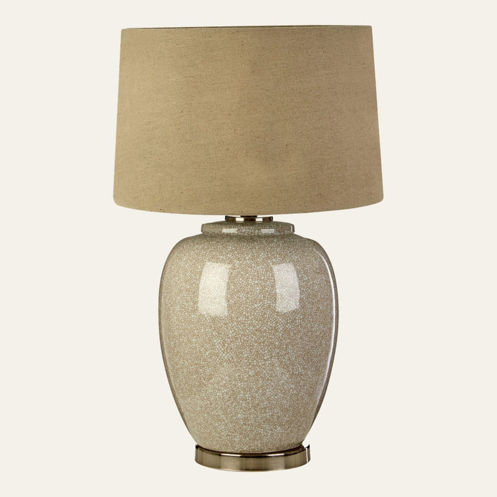 Orielle Ceramic Table Lamp with glossy crackle-glazed beige ceramic vase base, brass-tone metal base and collar, and natural linen drum shade