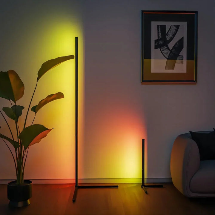 Modern living room with a plant, floor lamp, and abstract art on the wall.