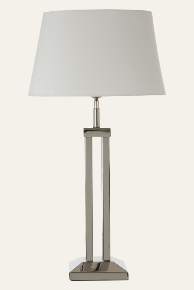 Selva Dual Rod Table Lamp with white tapered drum shade and polished nickel dual-rod base on a square platform