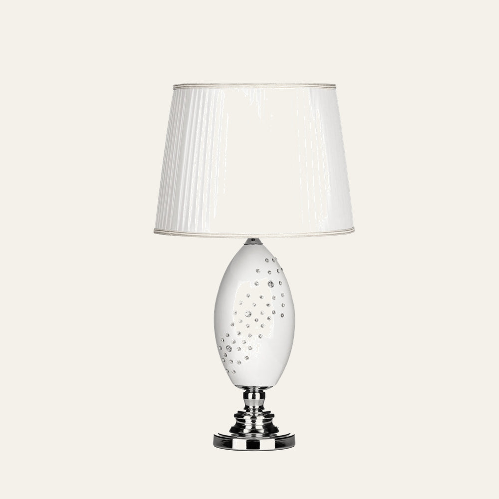Serelle Table Lamp with white pleated fabric shade, glossy white oval ceramic base studded with crystal accents and polished chrome pedestal