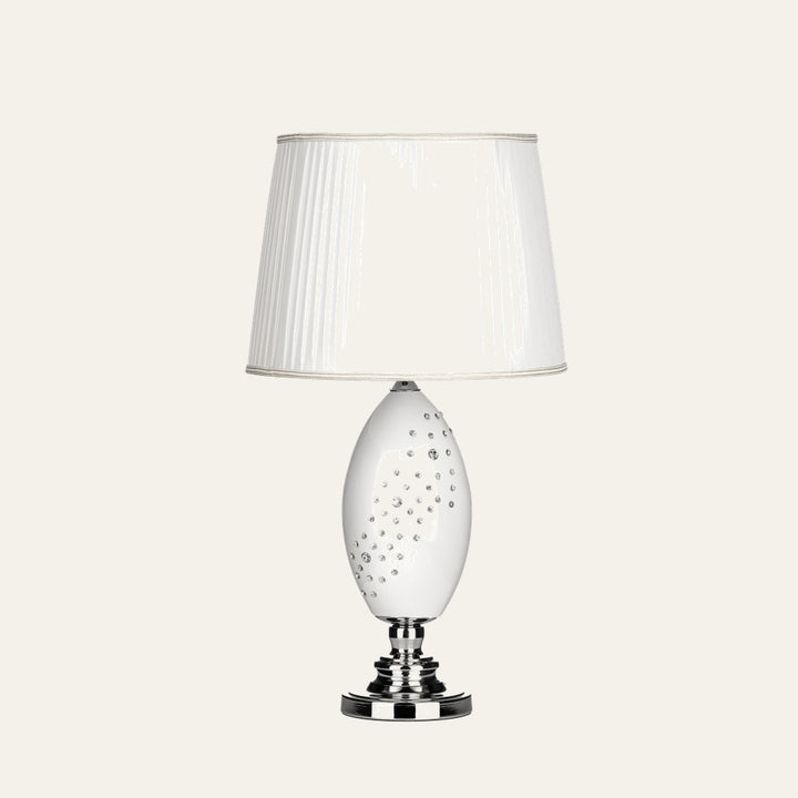 Serelle Table Lamp with white pleated fabric shade, glossy white oval ceramic base studded with crystal accents and polished chrome pedestal