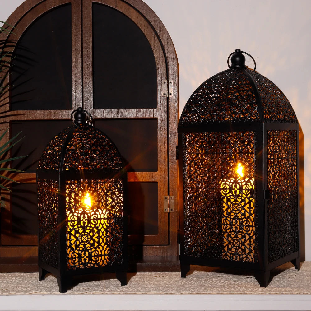 Two ornate metal lanterns with warm glow in front of a wooden door.