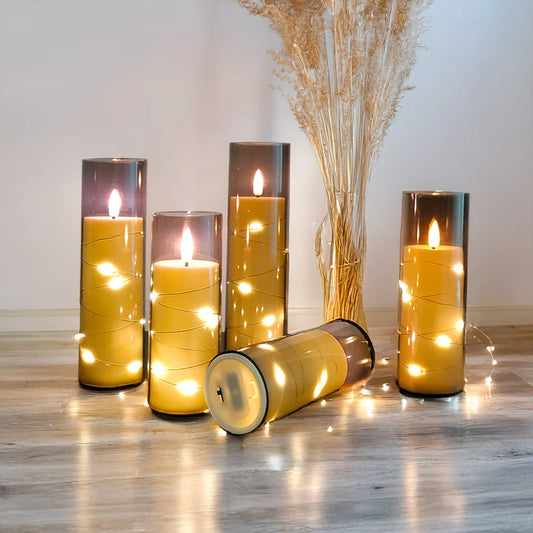 Decorative candles with string lights on a wooden floor