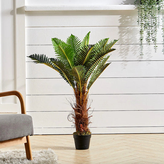 Potted plant in a room with a wooden floor and white wall