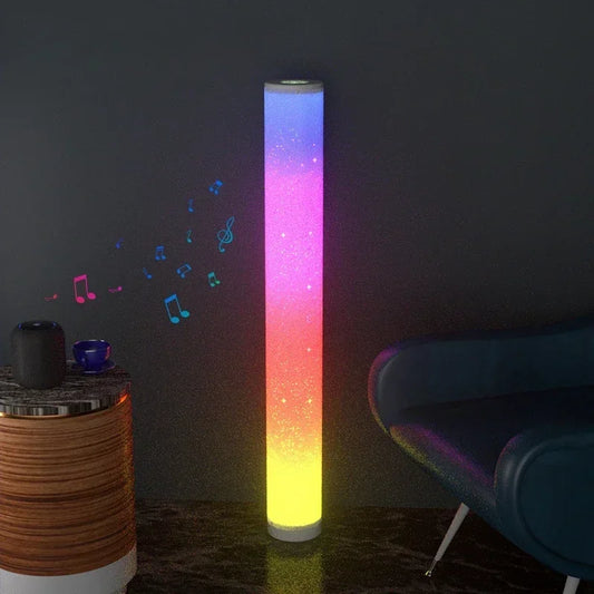 Colorful cylindrical light emitting musical notes on a dark wall