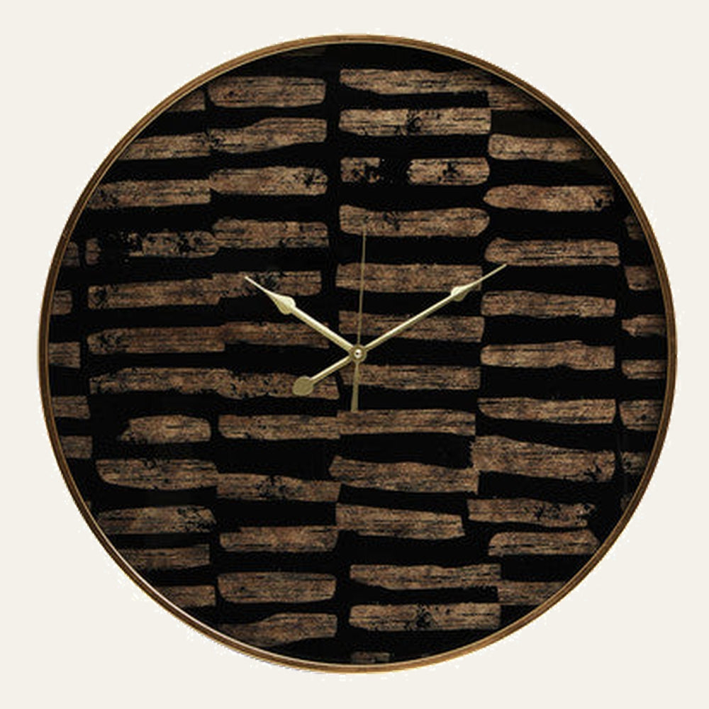 Soren Wall Clock with round gold metal frame and gold hands on a black face decorated with irregular brown wood‑like horizontal brushstroke pattern