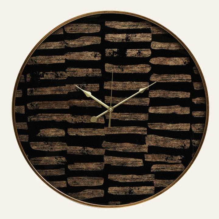Soren Wall Clock with round gold metal frame and gold hands on a black face decorated with irregular brown wood‑like horizontal brushstroke pattern