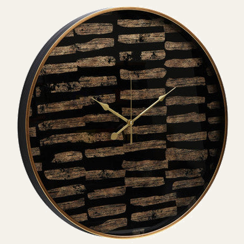 Soren Wall Clock, round clock with black face patterned with distressed horizontal brown brushstroke stripes, thin gold rim and gold metal hands