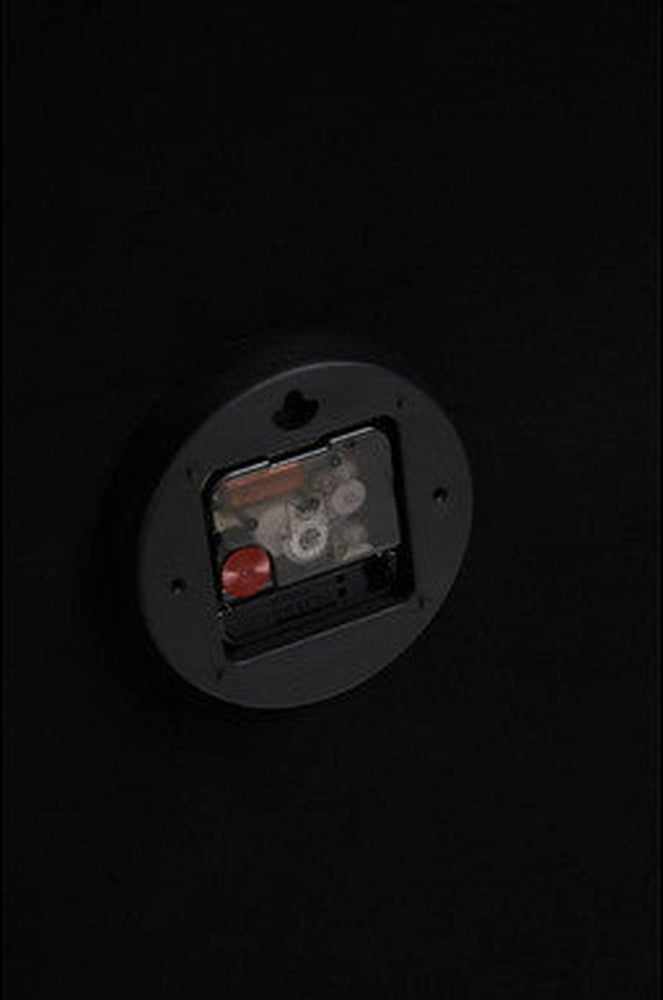 Soren Wall Clock back view showing round black plastic movement housing with exposed battery compartment and keyhole hanger