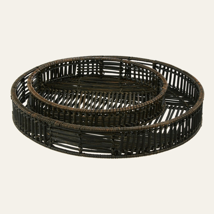 Tavren Black Rattan Tray Set — two round nested woven rattan trays in black with open slatted sides and low rims
