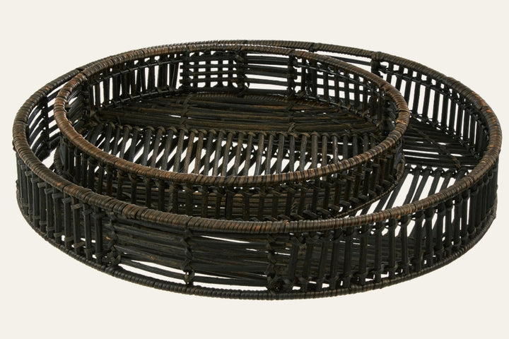 Tavren Black Rattan Tray Set: two nested round trays in black rattan with open woven sides and low raised rims