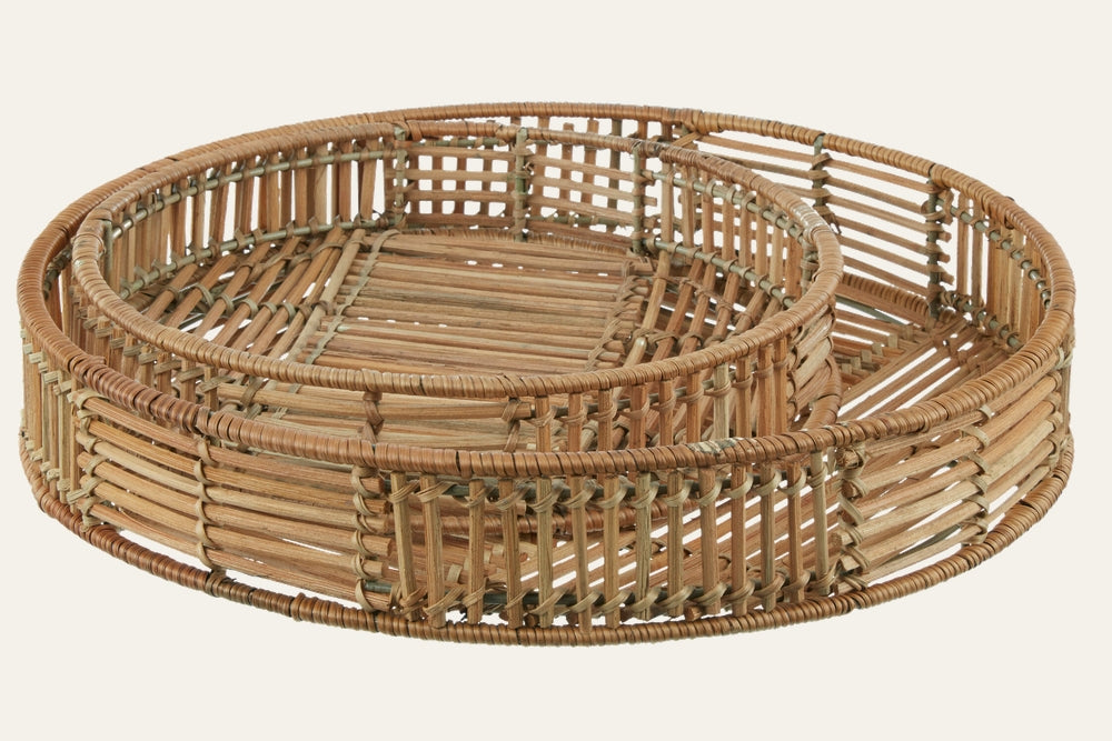 Tavren Natural Rattan Tray Set — two round nesting trays in natural rattan with open slatted weave, wrapped rims, and warm tan finish