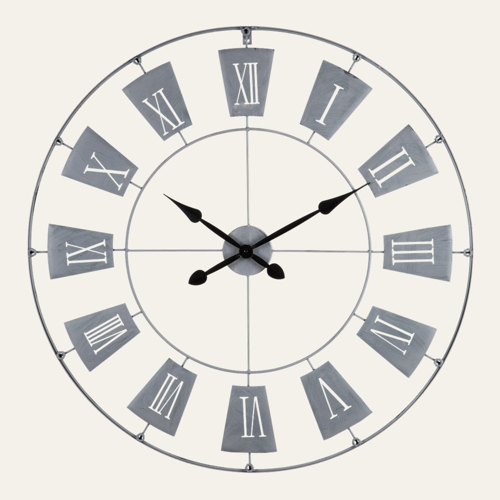 Torin Metal Large Wall Clock — round open metal frame with gray trapezoid number plates, white Roman numerals and black decorative hands