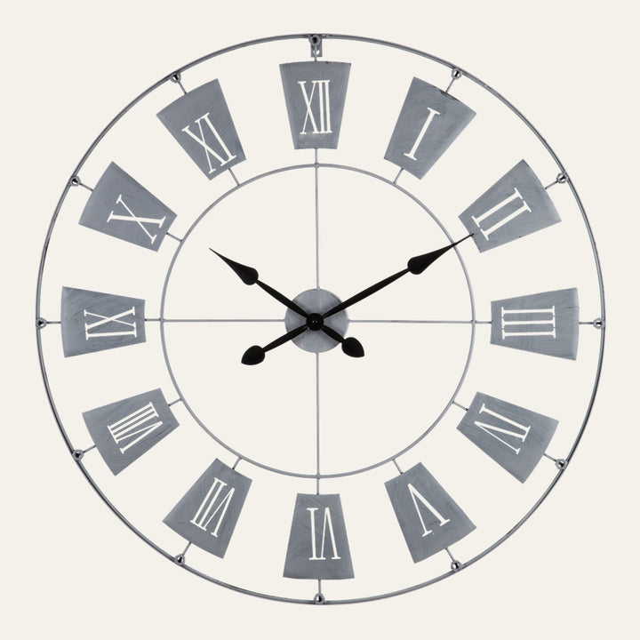Torin Metal Large Wall Clock — round open metal frame with gray trapezoid number plates, white Roman numerals and black decorative hands