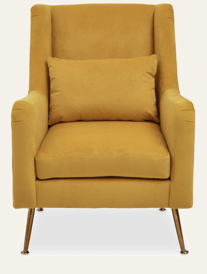 Varela Velvet Chair — mustard yellow velvet high-back armchair with loose seat cushion and lumbar pillow, slim tapered metal legs with brass finish.