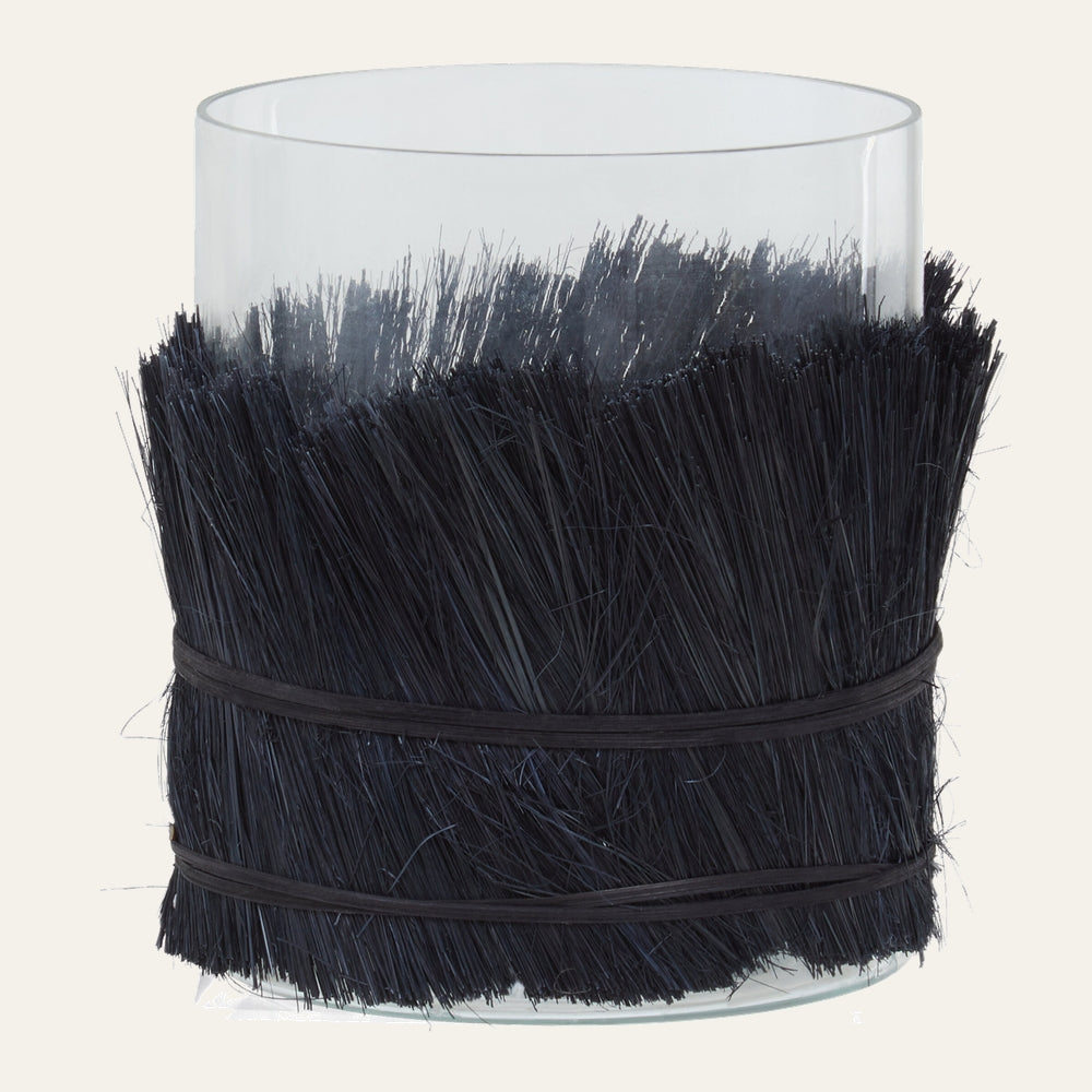 Velora Candle Holder clear glass cylinder wrapped mid-height in dense black straw-like bristles, secured with two thin black bands