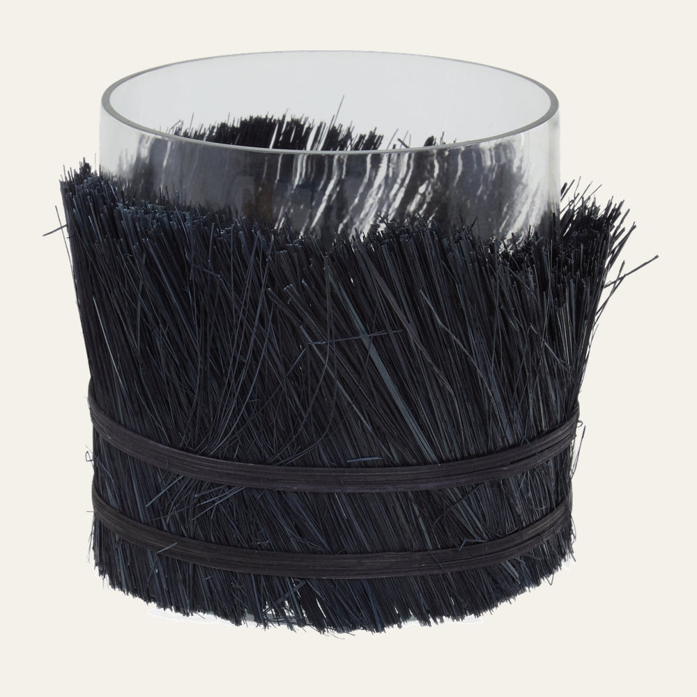 Velora Candle Holder — clear glass cylinder wrapped in dense black straw-like bristles secured with two black bands