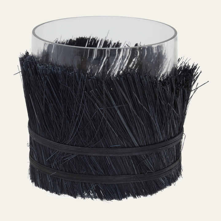 Velora Candle Holder — clear glass cylinder wrapped in dense black straw-like bristles secured with two black bands