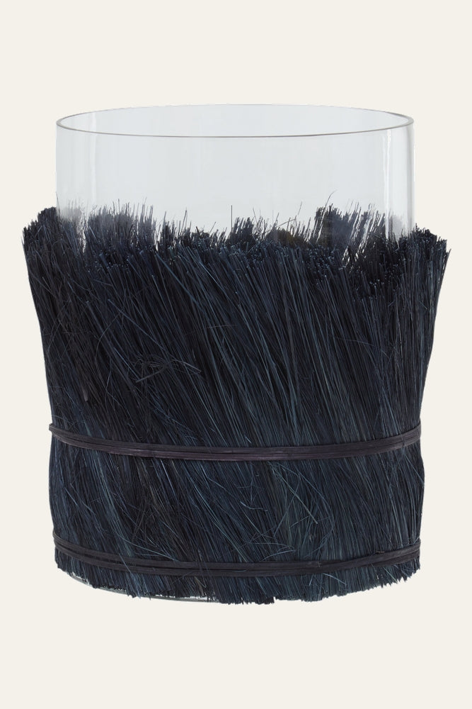 Velora Candle Holder — clear cylindrical glass with dense dark bristle wrap around the lower half, secured by two thin dark bands.