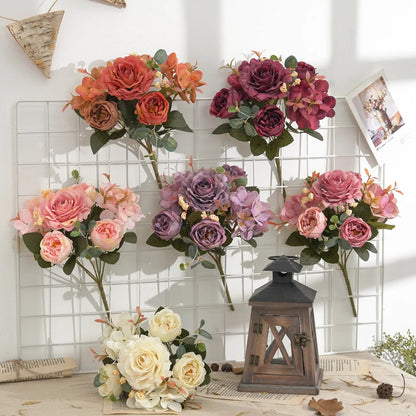 Set of artificial flower bouquets in various colors on a decorative surface with a lantern.