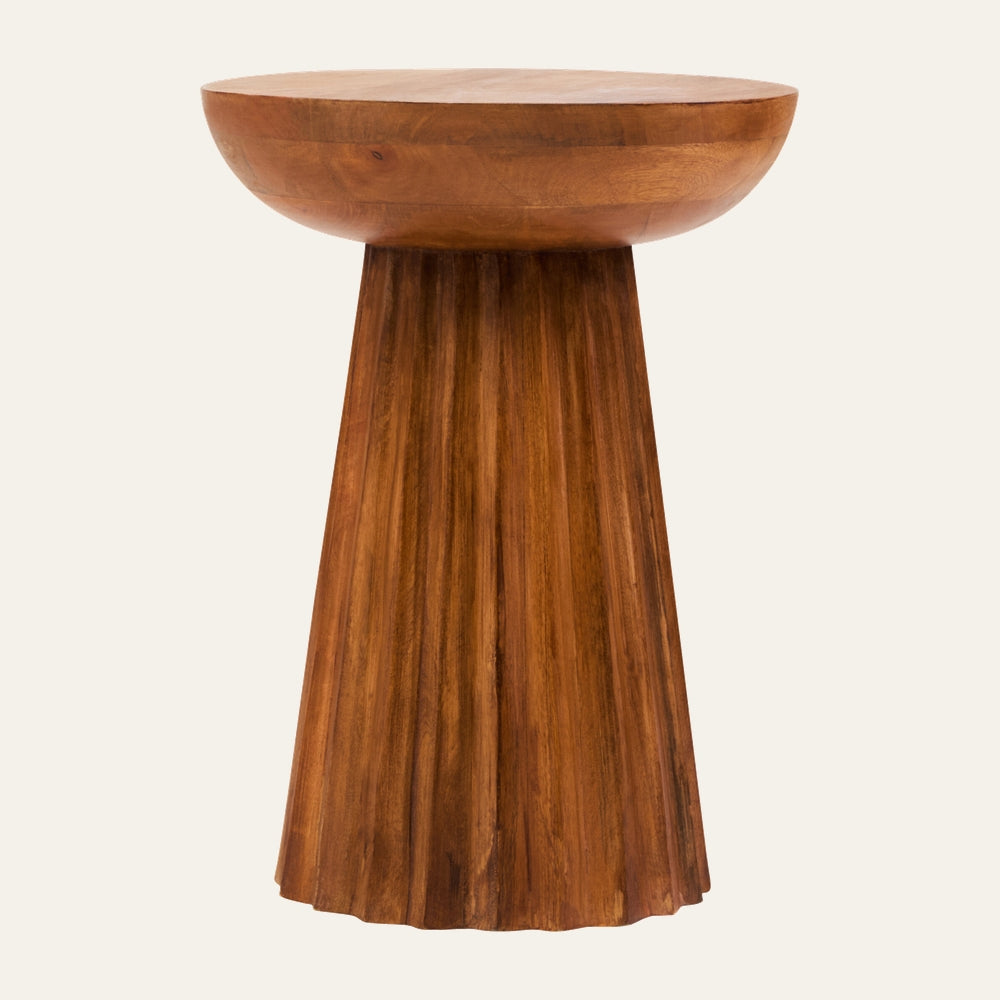 Wesric Carved Ridge Side Table with a round thick wooden top and carved, fluted tapered pedestal base in warm brown wood grain finish