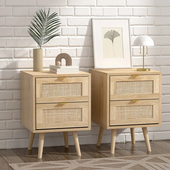 Two wooden nightstands with rattan drawers against a white brick wall.