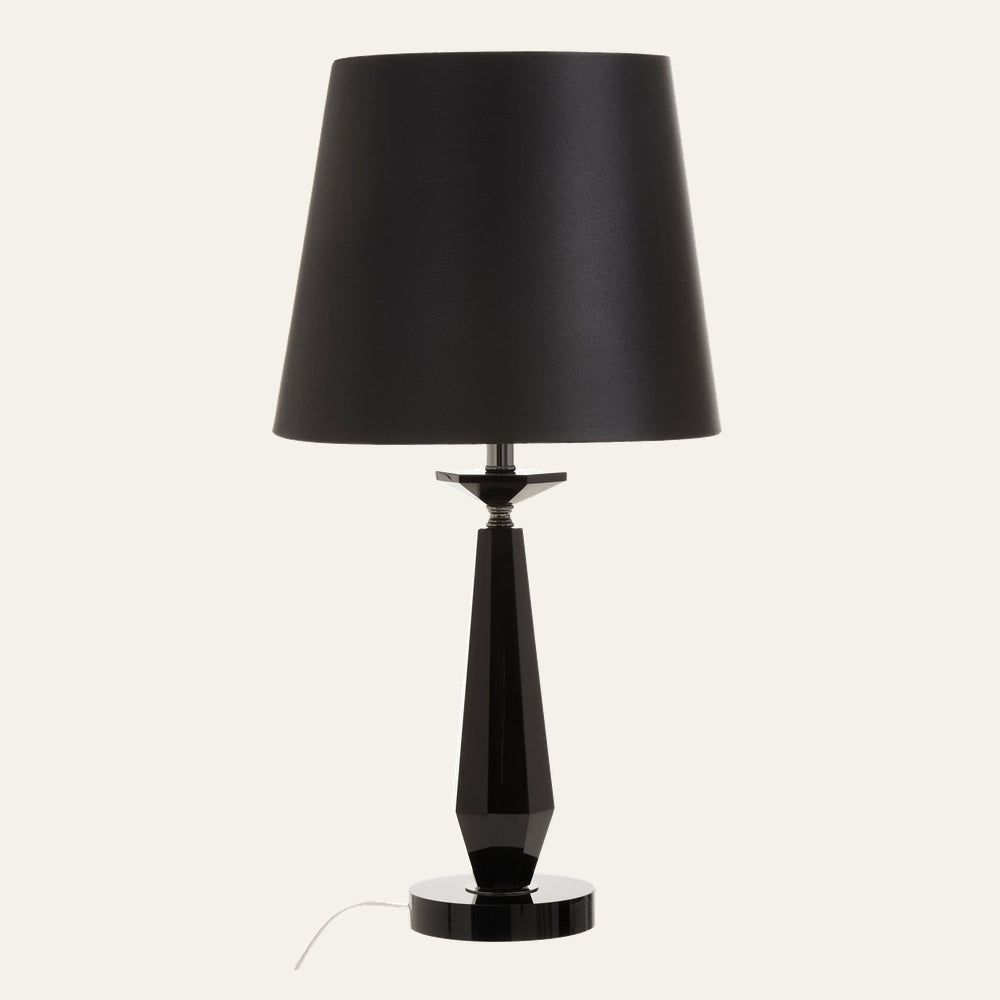 Wrenor Crystal Glass Table Lamp with black tapered fabric shade, faceted glossy black crystal glass column, chrome accent and round glossy black base.