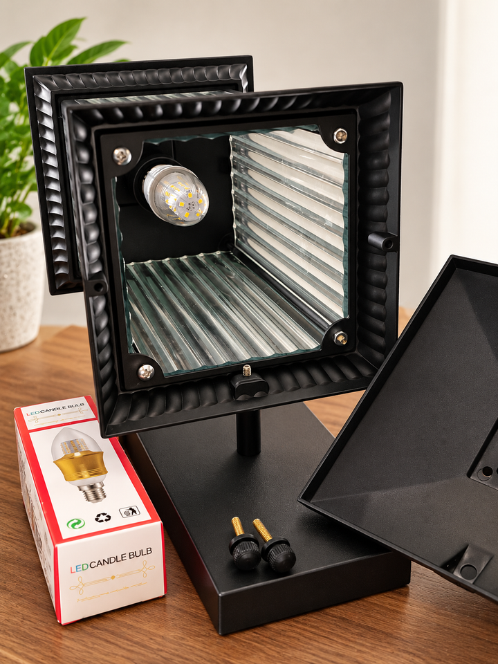 Black outdoor wall light opened to show easy access to the replaceable E27 LED bulb