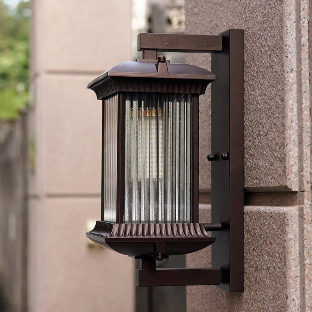 Black aluminium outdoor wall light with ribbed glass panels shown unlit